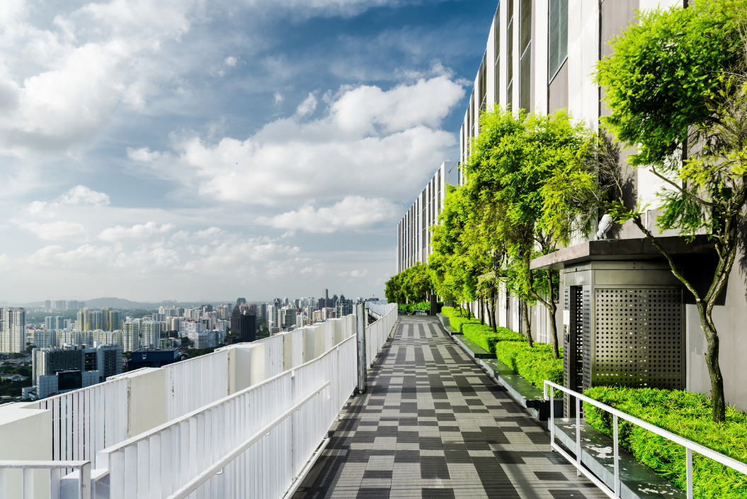 A lush green roof with thriving plants atop a condominium building, showcasing eco-friendly design.